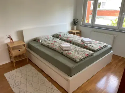 a bed in a room with two pillows on it at Mely Rose in Ljubljana