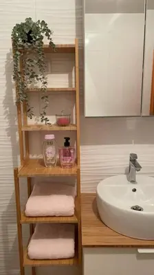 a bathroom with a sink and a shelf with towels at Mely Rose in Ljubljana