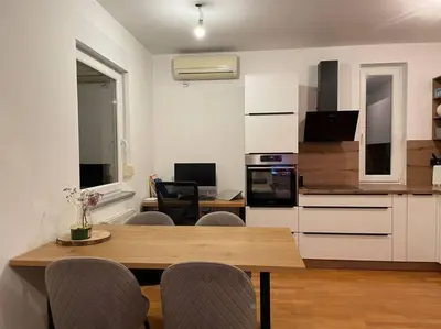 a kitchen with a table and chairs in a room at Mely Rose in Ljubljana