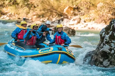 a group of people in a raft on a river at Hostel Soča Rocks in Bovec
