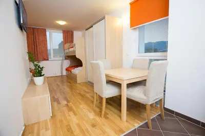 a small dining room with a table and chairs at Apartments Benedičič in Bled