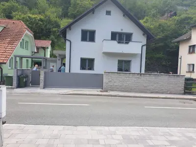 a white house on the side of a street at Apartma Sava-Stol in Jesenice