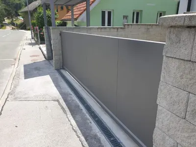 a white fence on the side of a street at Apartma Sava-Stol in Jesenice