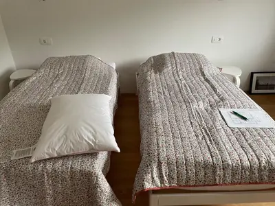 two beds sitting next to each other in a room at Apartma Sava-Stol in Jesenice