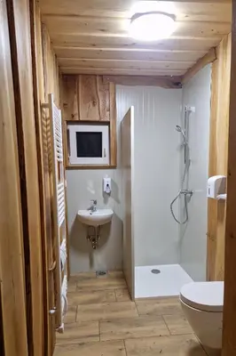 a bathroom with a sink and a toilet and a shower at Cowboy's Land in Višnja Gora