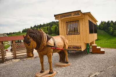 a statue of a horse standing in front of a building at Cowboy's Land in Višnja Gora