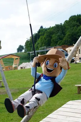 a statue of mickey on a swing at a park at Cowboy's Land in Višnja Gora
