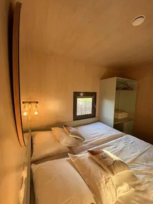 a bedroom with a bed in a small room at MAGNOLIA HOUSE by the RIVER XL in Metlika