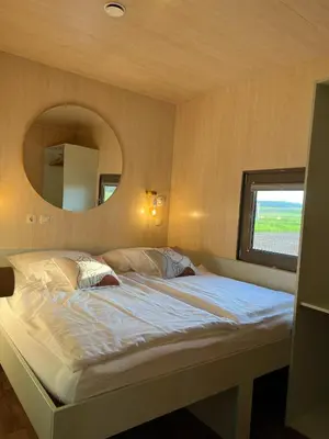 a bedroom with a large bed with a mirror at MAGNOLIA HOUSE by the RIVER XL in Metlika