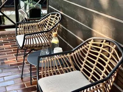 two chairs and a table with a bottle of wine at Olimian Oasis Village Lipa 107 in Podčetrtek