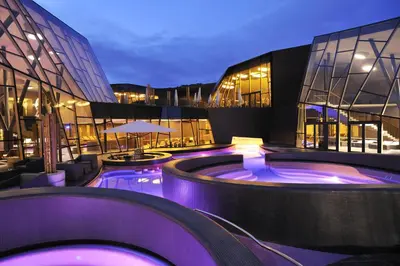 a building with a swimming pool in front of a building at Olimian Oasis Village Lipa 107 in Podčetrtek