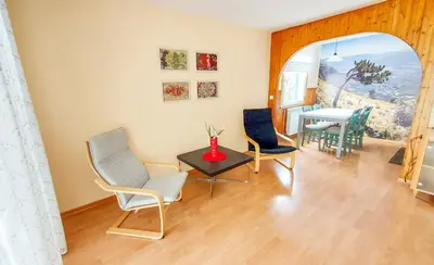 a living room with chairs and a table at Apartment Otava in Šempas