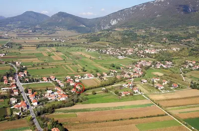 an aerial view of a village in a valley with mountains at Apartment Otava in Šempas