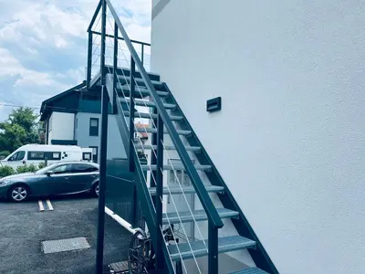 a staircase leading up to a building with a car at Villa Kovačeva 15, app 2, free parking in Ljubljana