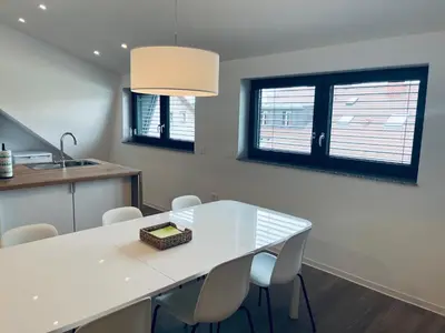 a kitchen with a white table and chairs at Villa Kovačeva 15, app 2, free parking in Ljubljana