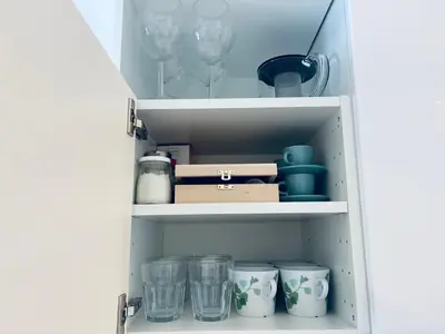 a cupboard filled with glasses and plates and cups at Villa Kovačeva 15, app 2, free parking in Ljubljana