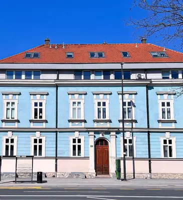 a large blue building with a red roof at Apartment VIČ in Ljubljana