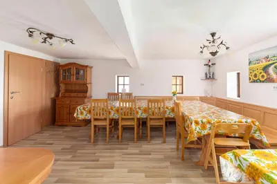 a dining room with a table and chairs at Sunflower House with Jacuzzy and Sauna in Vitanje