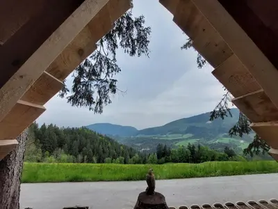 a view of the mountains from the porch of a house at Sunflower House with Jacuzzy and Sauna in Vitanje
