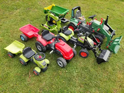 a group of toy tractors sitting on the grass at Sunflower House with Jacuzzy and Sauna in Vitanje