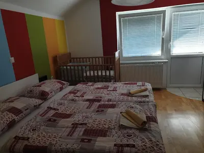 two beds in a bedroom with a quilt on them at Apartma ob potoku in Luče
