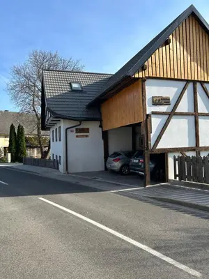a building with a parking lot with a car garage at Slovenian House Vida in Bled