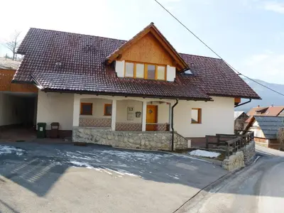 a white house with a brown roof at Apartment Jalps 2 in Bohinj