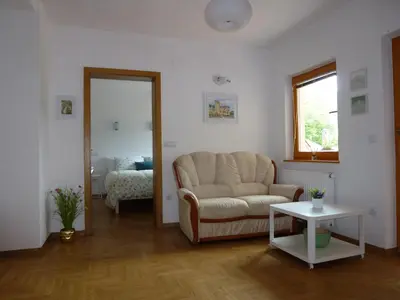 a living room with a couch and a table at Apartment Jalps 2 in Bohinj
