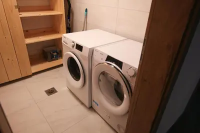 a washer and dryer in a laundry room at Apartma Gorski razgled in Srednja Vas v Bohinju