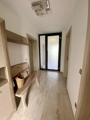 a living room with a bench and a large window at Hiša Helena in Kranj
