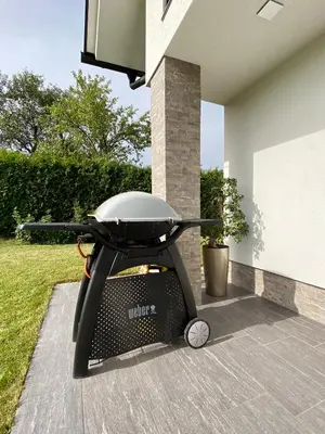 a barbecue grill sitting outside of a house at Hiša Helena in Kranj