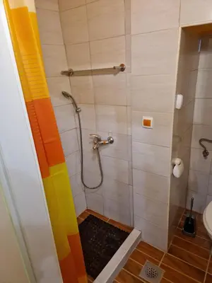 a bathroom with a shower with a rainbow curtain at Studio Lotrist in Radovljica