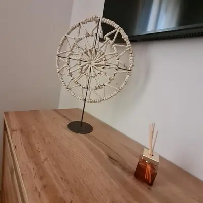 a metal fan on a wooden table next to a wall at Soba pri nam in Gačnik