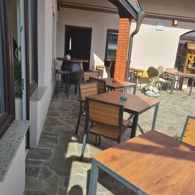 a restaurant with tables and chairs in a room at Soba pri nam in Gačnik