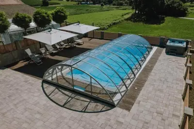 a glass dome with a swimming pool in it at Soba pri nam in Gačnik
