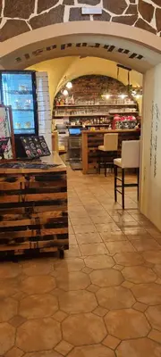 a store with a counter and chairs in a room at Apartma Rešer in Črna na Koroškem