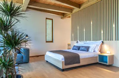 a bedroom with a bed and two potted plants at Studio na Stolbi in Ljubljana