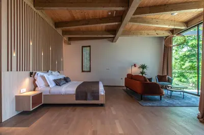 a bedroom with a bed and a desk and a chair at Studio na Stolbi in Ljubljana