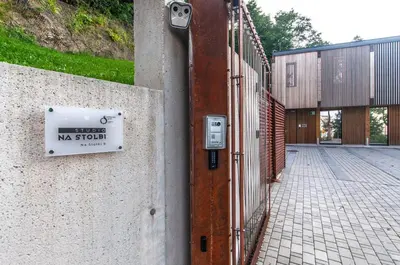 a sign on a wall next to a fence at Studio na Stolbi in Ljubljana