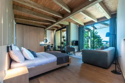 a bedroom with a large bed and a large window at Studio na Stolbi in Ljubljana