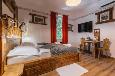 a bedroom with a large wooden bed and a window at Rooms Murka in Bled