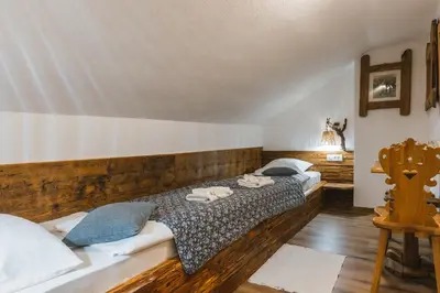 a bedroom with two beds with towels on them at Rooms Murka in Bled