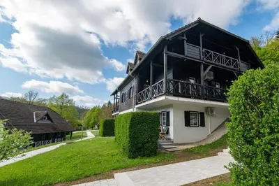 a black and white house with a balcony at MIZU APARTMA VAS LIPA OLIMJE in Podčetrtek