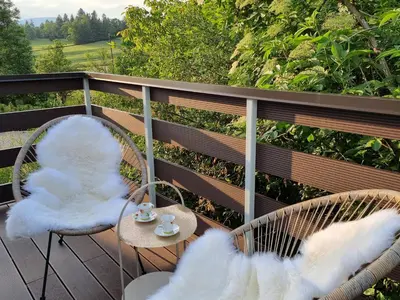 a balcony with two chairs and a table with a view at Apartma Katarina in Bled