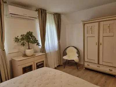 a bedroom with a bed and a chair and a plant at Apartma Katarina in Bled