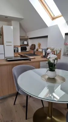 a kitchen with a glass table with a vase of flowers on it at Apartma Katarina in Bled
