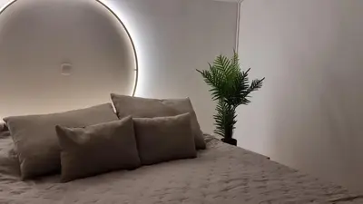 a bedroom with a bed with a mirror and a plant at Apartma Katarina in Bled