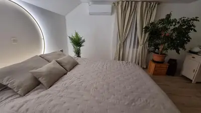 a bedroom with a large white bed with two pillows at Apartma Katarina in Bled