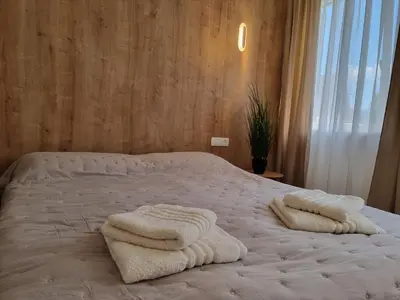 a bed with two towels on top of it at Apartma Larisa in Bled