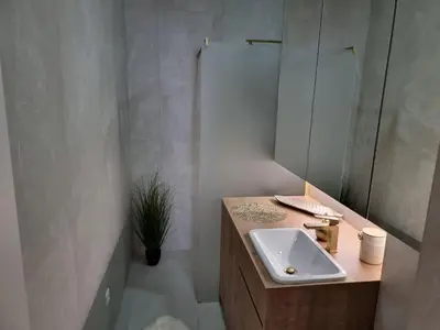 a bathroom with a sink and a mirror at Apartma Larisa in Bled